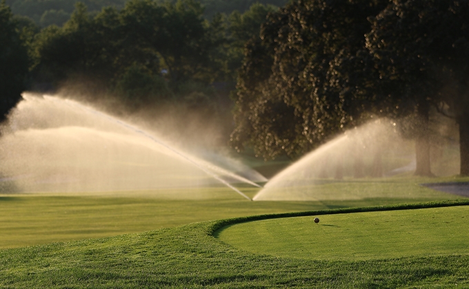 Image of sprinklers on a golf course