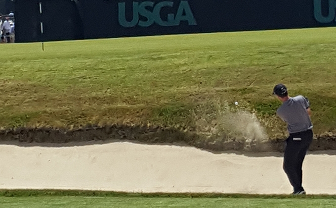 golfer hitting out of a bunker